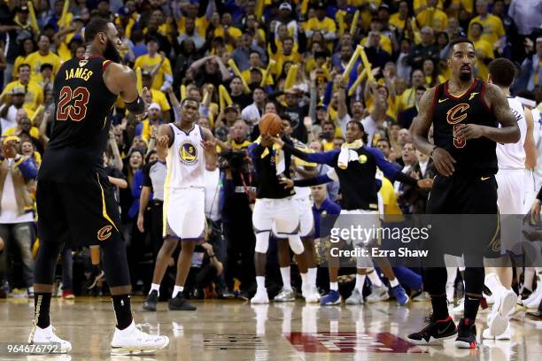 LeBron James and JR Smith of the Cleveland Cavaliers react as time expries in regulation against the Golden State Warriors in Game 1 of the 2018 NBA...