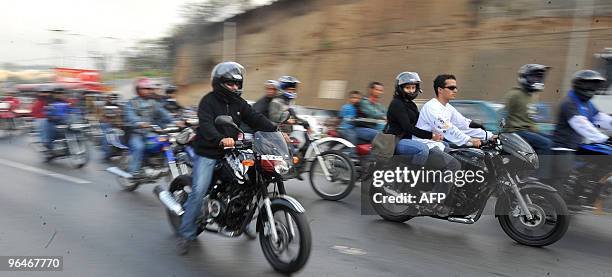 Motorcycle riders take part in the caravan known as "La Caravana del Zorro" as they head out of Guatemala City on their way to Esquipulas on February...