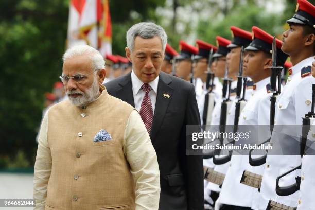 Indian Prime Minister Narendra Modi inspects the guard of honour, accompanied by Singapore Prime Minister, Lee Hsien Loong during the welcome...