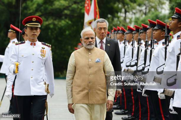 Indian Prime Minister Narendra Modi inspects the guard of honour, accompanied by Singapore Prime Minister, Lee Hsien Loong during the welcome...