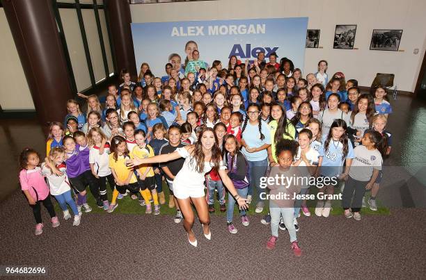 Professional soccer player Alex Morgan poses for a photo with young soccer fans during the premiere of "Alex & Me" at the DGA Theater on May 31, 2018...