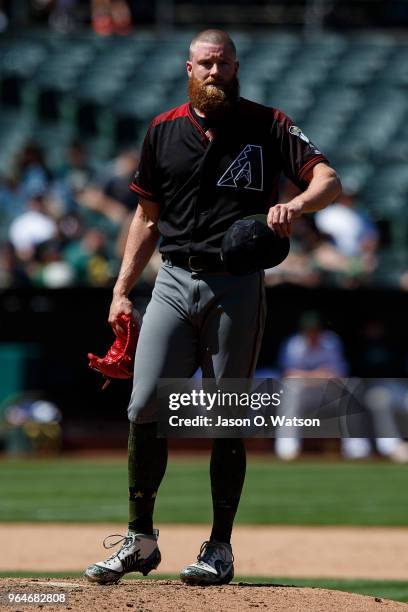 Archie Bradley of the Arizona Diamondbacks stands on the pitchers mound against the Oakland Athletics during the seventh inning at the Oakland...