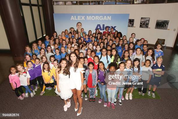 Actor Siena Agudong and professional soccer player Alex Morgan pose for a photo with young soccer fans during the premiere of "Alex & Me" at the DGA...