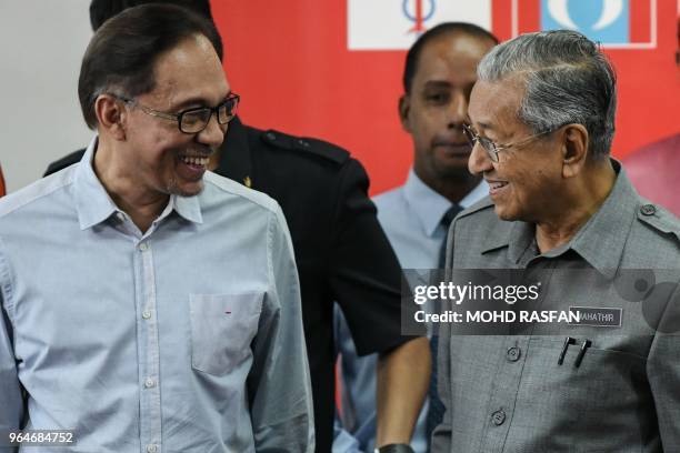 Malaysia's Prime Minister Mahathir Mohamad and politician Anwar Ibrahim, leave after a press conference in Kuala Lumpur on June 1, 2018.