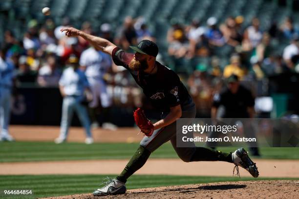 Archie Bradley of the Arizona Diamondbacks pitches against the Oakland Athletics during the seventh inning at the Oakland Coliseum on May 27, 2018 in...