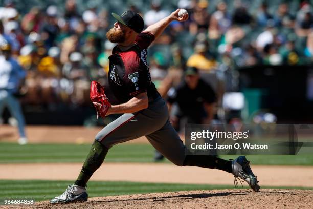 Archie Bradley of the Arizona Diamondbacks pitches against the Oakland Athletics during the seventh inning at the Oakland Coliseum on May 27, 2018 in...