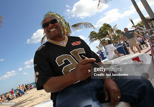 Saints fan Kenny Gibbs of Fort Lauderdale, smokes a cigar on Fort Lauderdale Beach on February 6, 2010 in Fort Lauderdale, Florida. Super Bowl XLIV...
