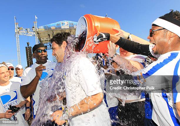 Mark Sanchez of the New York Jets celebrates with Michael Clarke Duncan and Marlon Wayans at the Fourth Annual DIRECTV Celebrity Beach Bowl at...