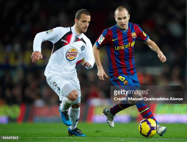 Andres Iniesta of FC Barcelona competes for the ball with Roberto Soldado of Getafe during the La Liga match between Barcelona and Getafe at Camp Nou...