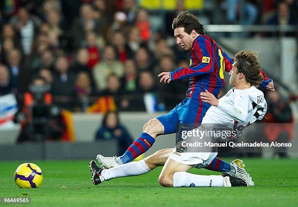 Lionel Messi of FC Barcelona competes for the ball with Rafa of Getafe during the La Liga match between Barcelona and Getafe at Camp Nou on February...