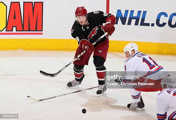 Shane Doan of the Phoenix Coyotes skates with the puck during the NHL game against the New York Rangers at Jobing.com Arena on January 30, 2010 in...