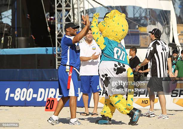 Hall of Famer Warren Moon high fives the mascot at the Fourth Annual DIRECTV Celebrity Beach Bowl at DIRECTV Celebrity Beach Bowl Stadium: South...