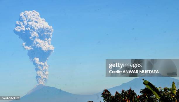 Mount Merapi spews volcanic ash on June 1, 2018 as seen from Karanganyar in Indonesia's Central Java province. - Mount Merapi's series of eruptions...