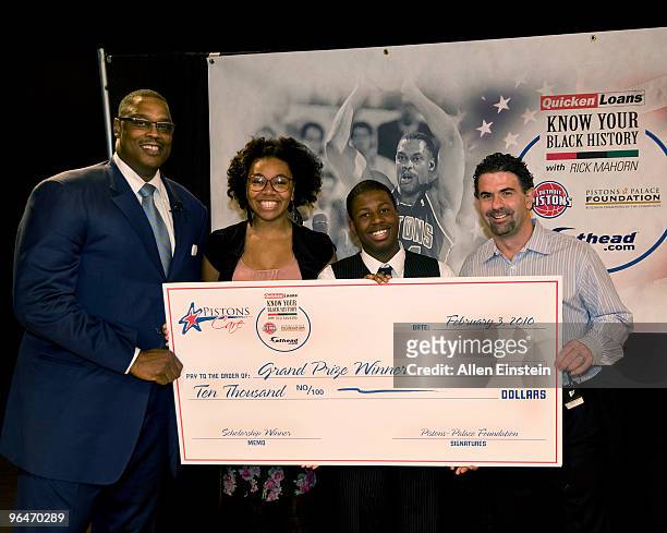 Rick Mahorn , Detroit Piston legend, and Patrick McGinnis , President and CEO of Fathead, present a $10,000 check to student winners from Cass Tech...