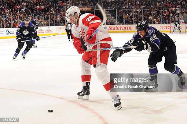Drew Miller of the Detroit Red Wings skates with the puck against Jarret Stoll of the Los Angeles Kings on February 6, 2010 at Staples Center in Los...