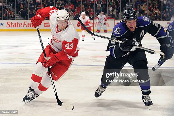 Darren Helm of the Detroit Red Wings looks for the puck against Matt Greene of the Los Angeles Kings on February 6, 2010 at Staples Center in Los...