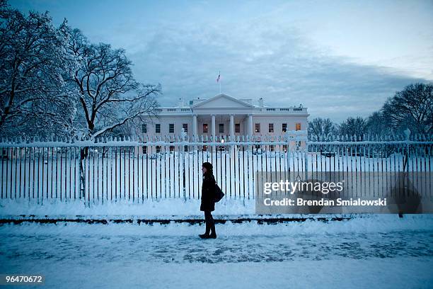 Woman walks on Pennsylvania Avenue in front of the White House after a snow storm February 6, 2010 in Washington, D.C. A record setting snowstorm has...