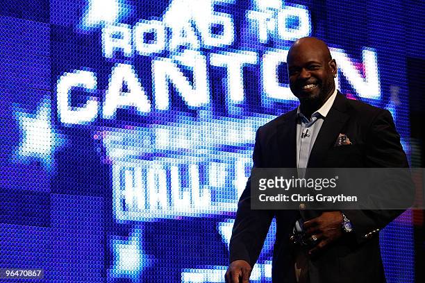 Emmitt Smith smiles as he walks on the stage after being announced as one of the newest enhrinees into the Hall of Fame during the Pro Football Hall...