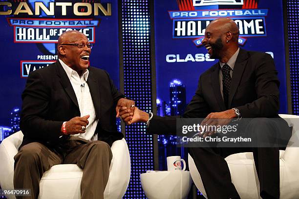 Floyd Little and Jerry Rice speak on stage after they both were announced as two of the newest enshrinees into the Hall of Fame during the Pro...