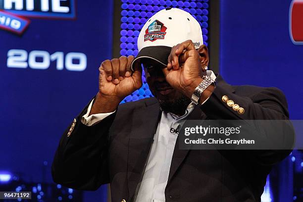 Emmitt Smith adjusts his hat on stage after he was announced as one of the newest enhrinees into the Hall of Fame during the Pro Football Hall of...