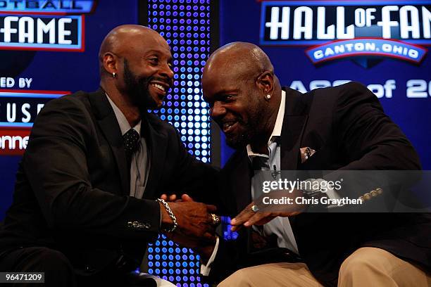 Jerry Rice and Emmitt Smith talk on stage after they were both announced as two of the newest enshrinees into the Hall of Fame during the Pro...