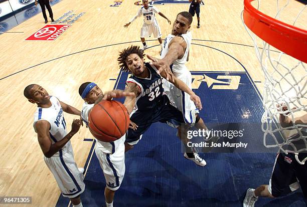 Steven Gay of the Gonzaga Bulldogs drives to the basket between Roburt Sallie and Will Coleman of the Memphis Tigers on February 6, 2010 at...