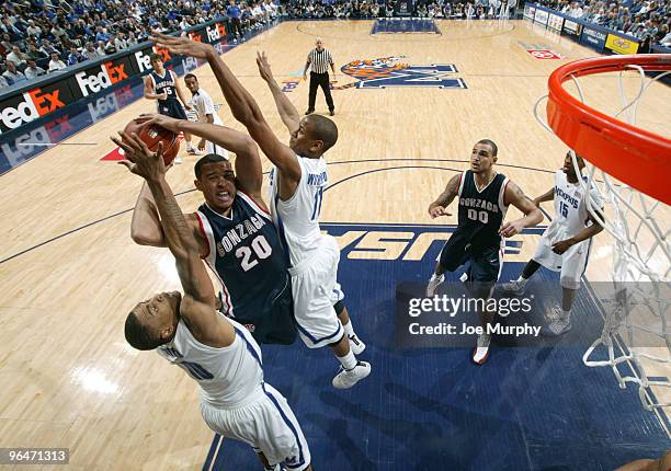 Will Coleman and Wesley Witherspoon of the Memphis Tigers attempt to block a shot attempt by Elias Harris of the Gonzaga Bulldogs on February 6, 2010...