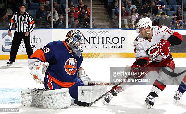 Sergei Samsonov of the Carolina Hurricanes is denied a scoring chance by Rick DiPietro of the New York Islanders on February 6, 2010 at Nassau...