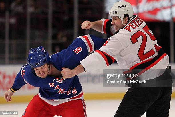 Brandon Prust of the New York Rangers fights with Andrew Peters of the New Jersey Devils during their game on February 6, 2010 at Madison Square...