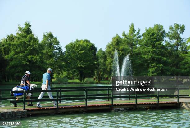 Jamie Donaldson of Wales and his caddie walk across a bridge on the 3rd hole during day two of the Italian Open at Gardagolf CC on June 1, 2018 in...