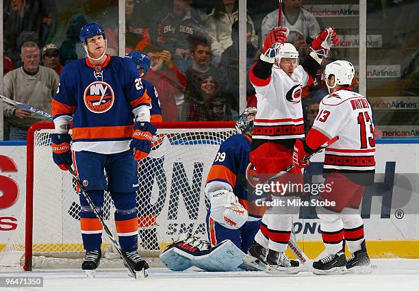 Jussi Jokinen of the Carolina Hurricanes celebrates his first period goal with teammate Ray Whitney as Andy Sutton of the New York Islanders looks on...