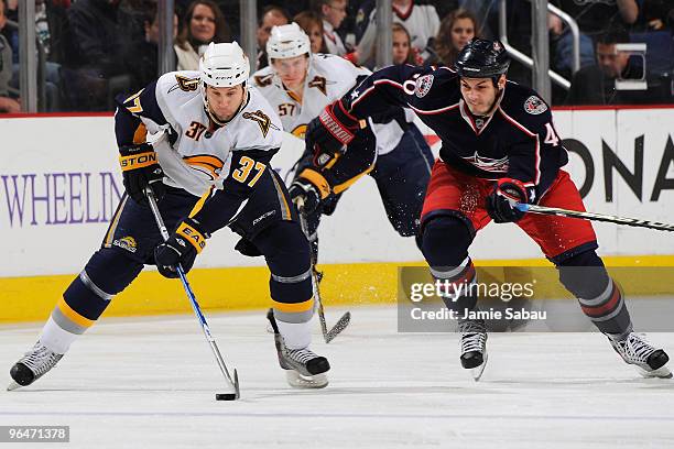 Jared Boll of the Columbus Blue Jackets chases after Matt Ellis of the Buffalo Sabres during the first period on February 6, 2010 at Nationwide Arena...