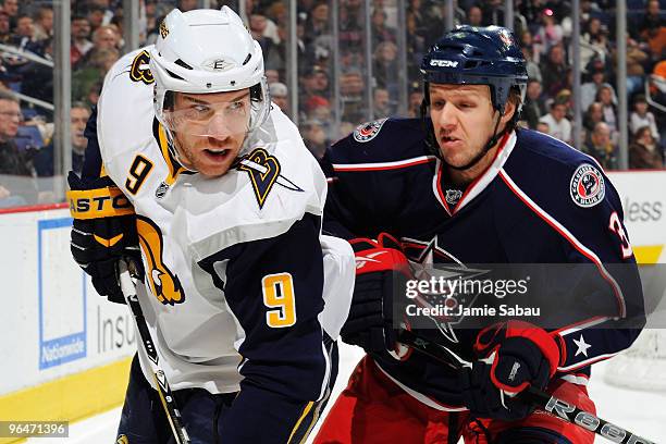 Marc Methot of the Columbus Blue Jackets prepares to check Derek Roy of the Buffalo Sabres during the first period on February 6, 2010 at Nationwide...