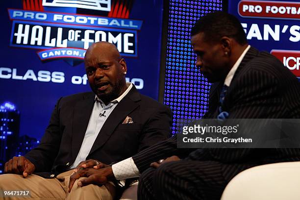 Michael Irvin comforts Emmitt Smith as Smith is overcome with emotion after Smith was announced as one of the newest enshrinees into the Hall of Fame...