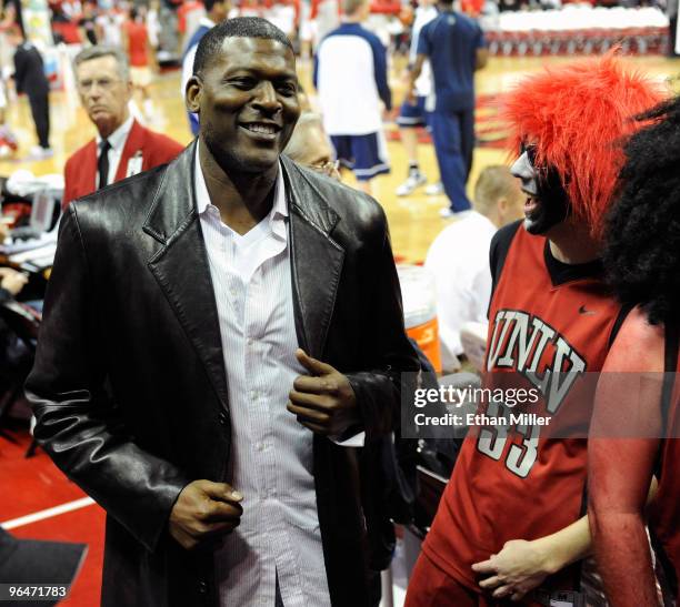 Former NBA and UNLV basketball player Larry Johnson greets fans before a game between the UNLV Rebels and the Brigham Young University Cougars at the...