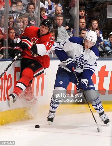 Fredrik Sjostrom of the Toronto Maple Leafs checks Filip Kuba of the Ottawa Senators during game action February 6, 2010 at the Air Canada Centre in...