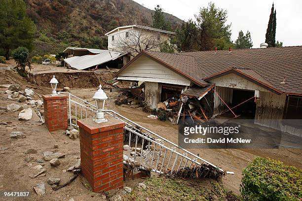 Debris flow damages a home after heavy rains caused mudslides February 6, 2010 in La Canada Flintridge, California. Large wildfires in 2008 and 2009...