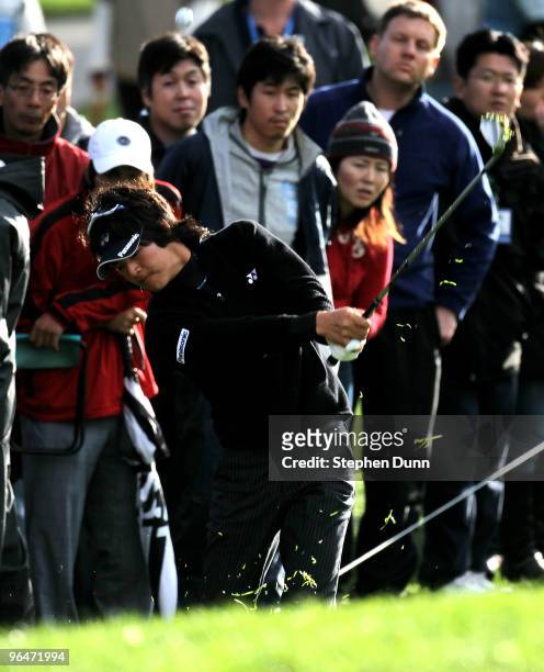 Ryo Ishikawa of Japan chips onto the 11th green during the third round of the Northern Trust Open at Riviera Country Club on February 6, 2010 in...