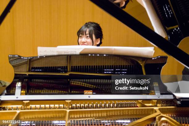 woman playing piano in a concert, rehearsal - pianist front stock pictures, royalty-free photos & images