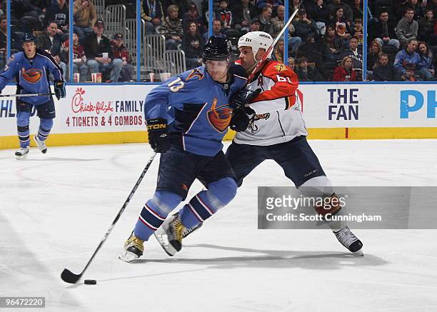 Vyacheslav Kozlov of the Atlanta Thrashers carries the puck against Cory Stillman of the Florida Panthers at Philips Arena on February 6, 2010 in...
