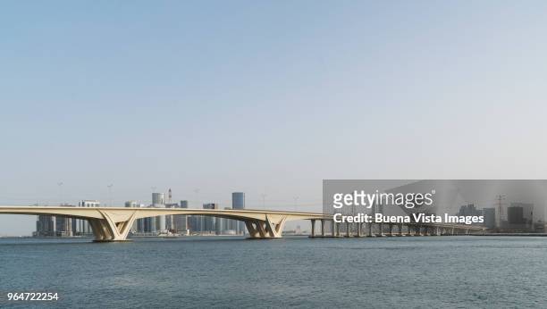 modern bridge and futuristic skyscrapers - abu dhabi bridge stock pictures, royalty-free photos & images