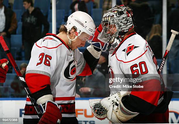 Jussi Jokinen of the Carolina Hurricanes who had a goal in the game congratulates Justin Peters on his first NHL win against the New York Islanders...