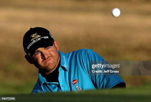 Holmes hits a pitch shot to the 13th green during the third round of the Northern Trust Open at Riviera Country Club on February 6, 2010 in Pacific...