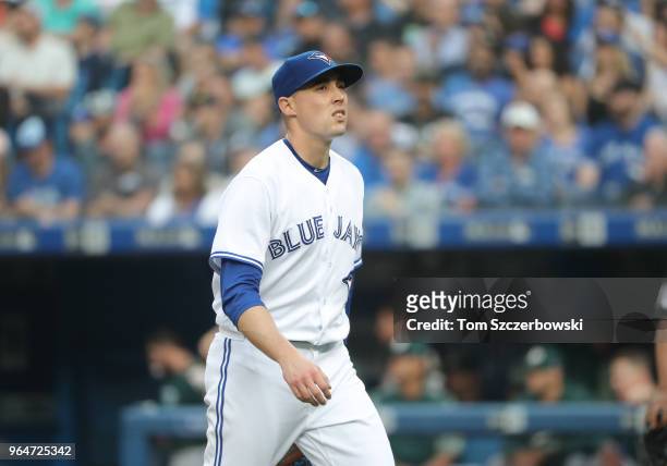 Aaron Sanchez of the Toronto Blue Jays walks off the mound towards his dugout after getting the last out of the second inning during MLB game action...