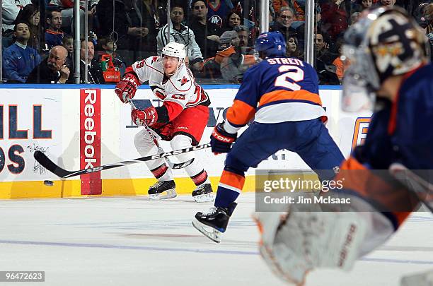 Joni Pitkanen of the Carolina Hurricanes scores his teams third goal past Mark Streit and Rick DiPietro of the New York Islanders on February 6, 2010...