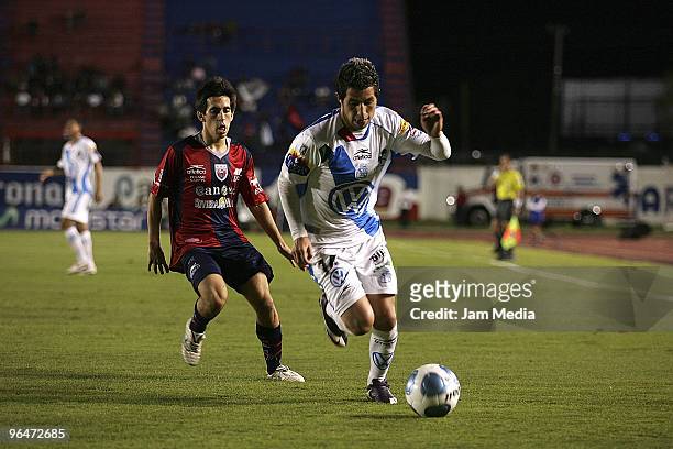 Atlante's player Fernando Navarro vies for the ball with Luis Miguel Noriega of Puebla during their match as part of the 2010 Bicentenary Tournament...