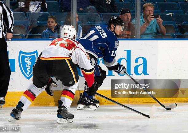 Jeff Halpern of the Tampa Bay Lightning controls the puck against Eric Nystrom of the Calgary Flames at the St. Pete Times Forum on February 6, 2010...