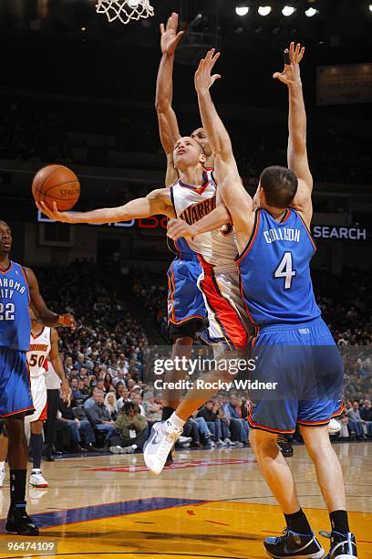 Stephen Curry of the Golden State Warriors attempts a circus shot against Nick Collison of the Oklahoma City Thunder on February 6, 2010 at Oracle...