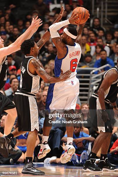 February 6: Bobby Brown of the Los Angeles Clippers goes up to pass against Roger Mason Jr. #8 of the San Antonio Spurs at Staples Center on February...