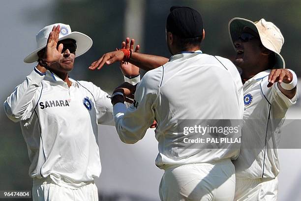 Indian cricketers Subramaniam Badrinath and Amit Mishra celebrate with teammate Harbhajan Singh after taking the wicket of South African cricketer...